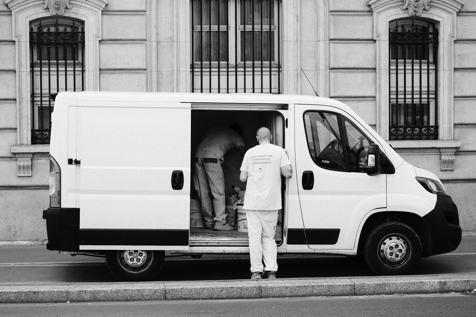 Movers loading a wrapped dresser into a box truck