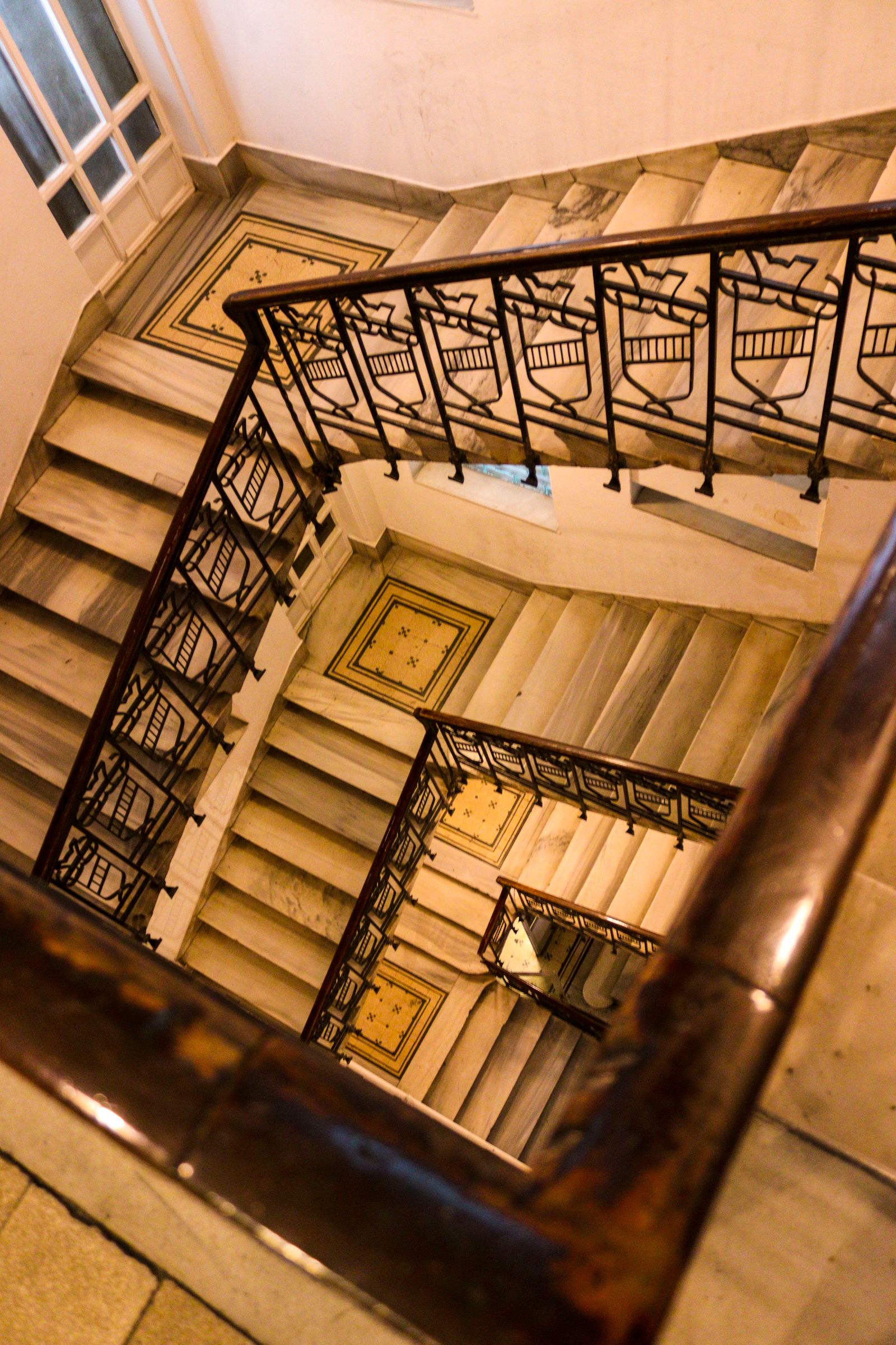 A narrow apartment stairwell in a San Diego walk-up